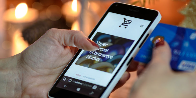 woman on smartphone ready to input credit card information to checkout