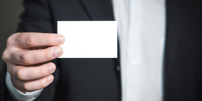 close-up of hand holding blank business card