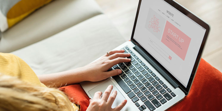 woman using laptop on her lap