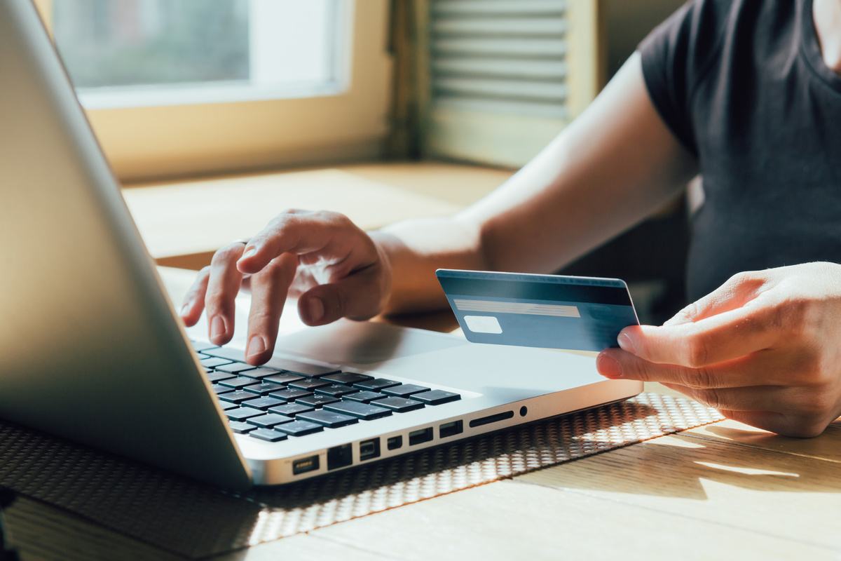 person typing financial data on computer